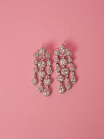 Load image into Gallery viewer, Elegant chandelier earrings on a pink background
