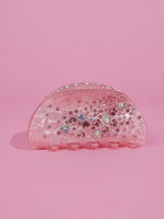 Load image into Gallery viewer, A translucent pink hair claw clip decorated with iridescent rhinestones, set against a solid pink background.

